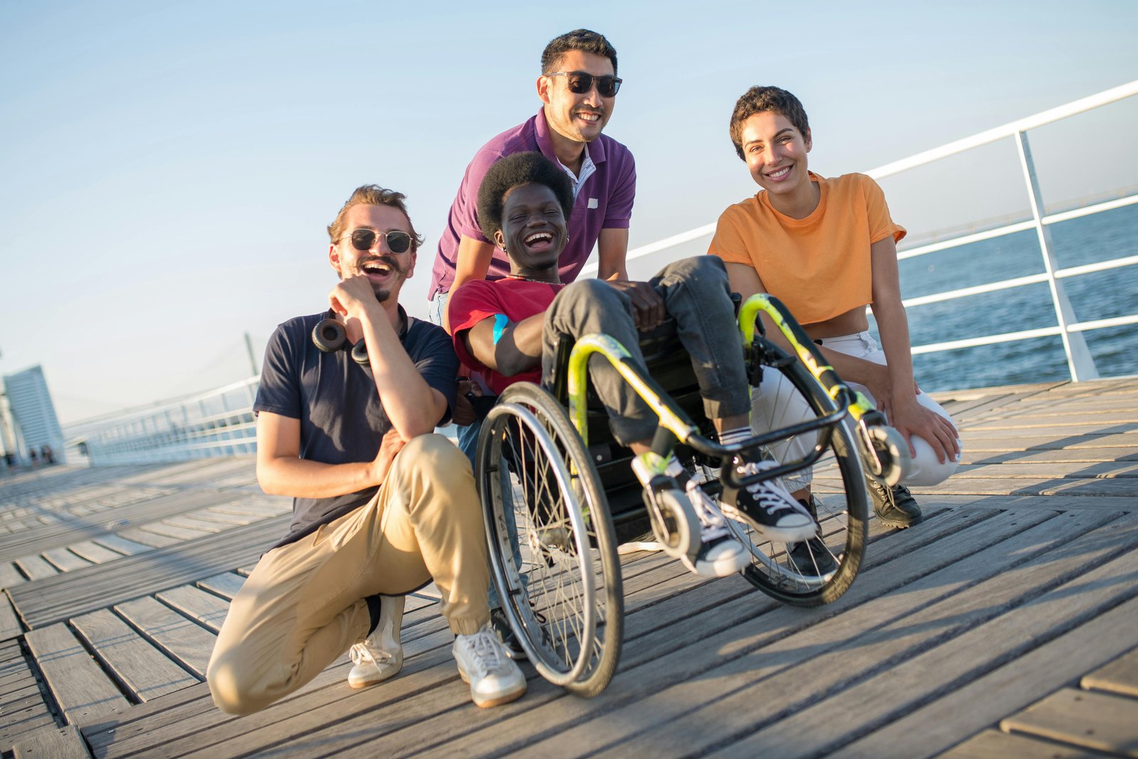 Inclusive group of people with a wheelchair user on a boardwalk